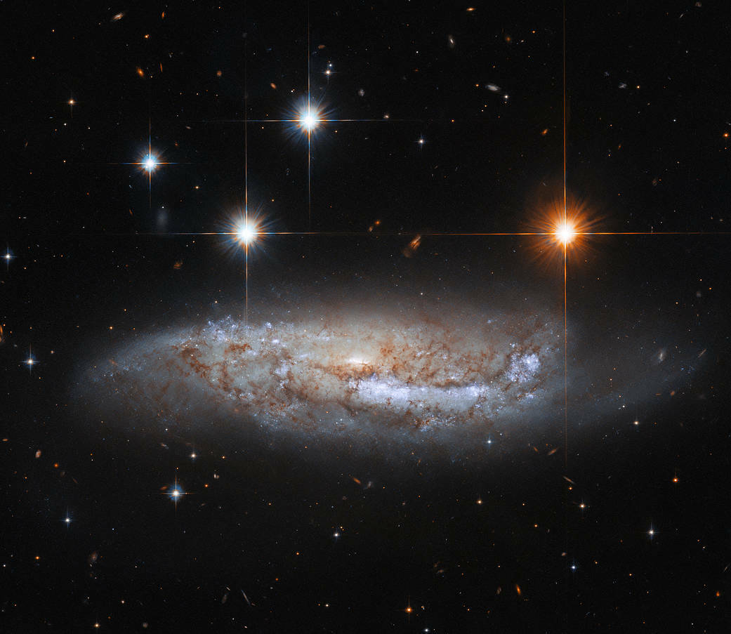 A side view of spiral galaxy NGC 3568, which is 57 million light-years from the Milky Way.