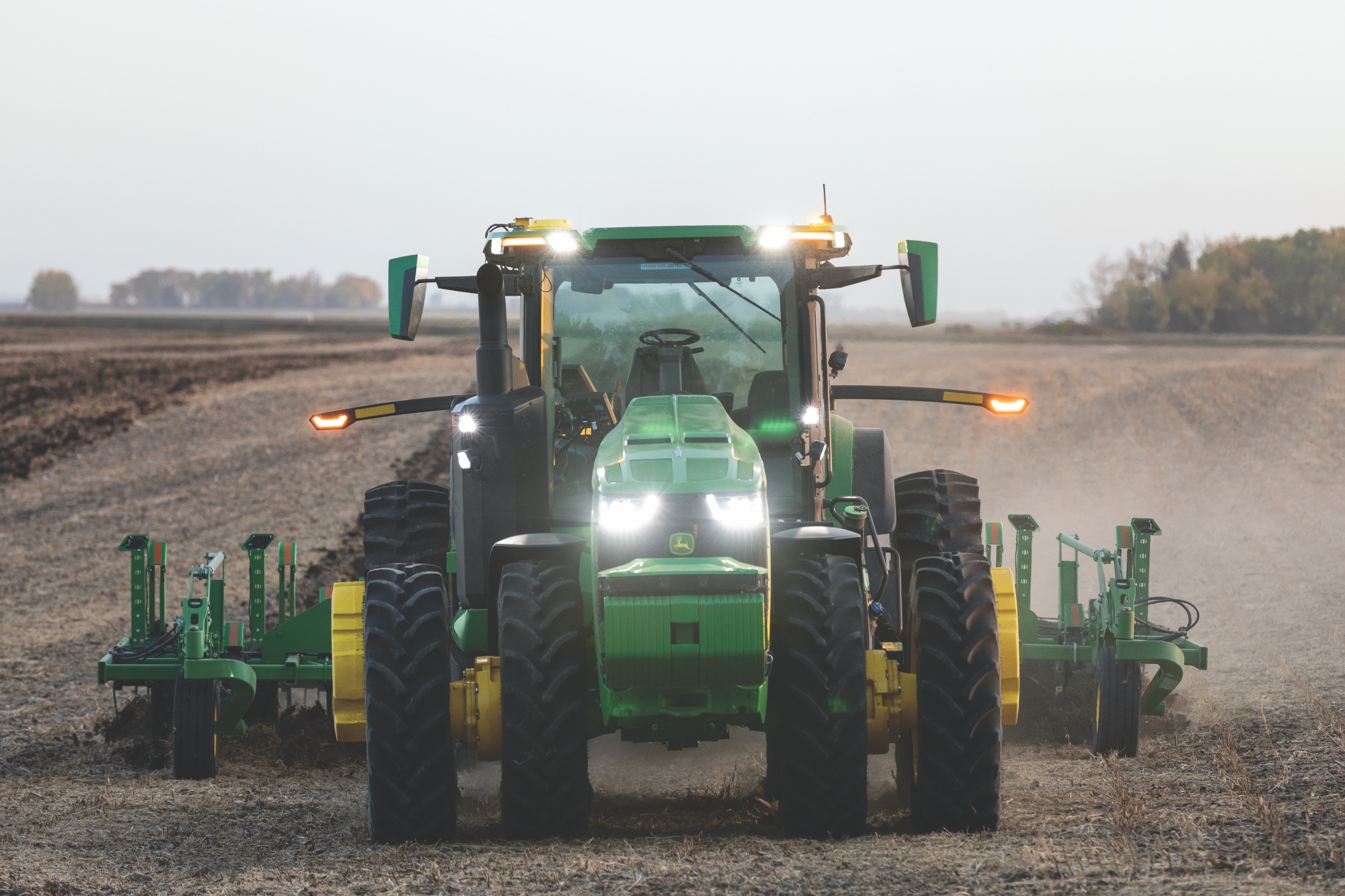 Green John Deere tractor facing front.