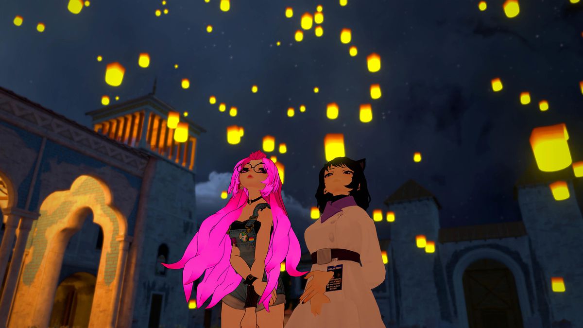 Two figures who resemble anime characters stand looking at lanterns that are floating into the sky.