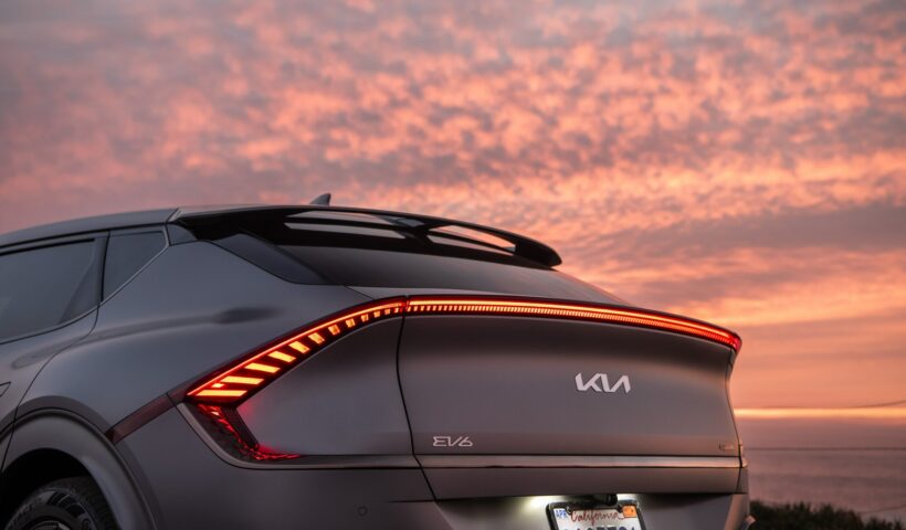 The back of the EV6 against a vibrant orange sunset.