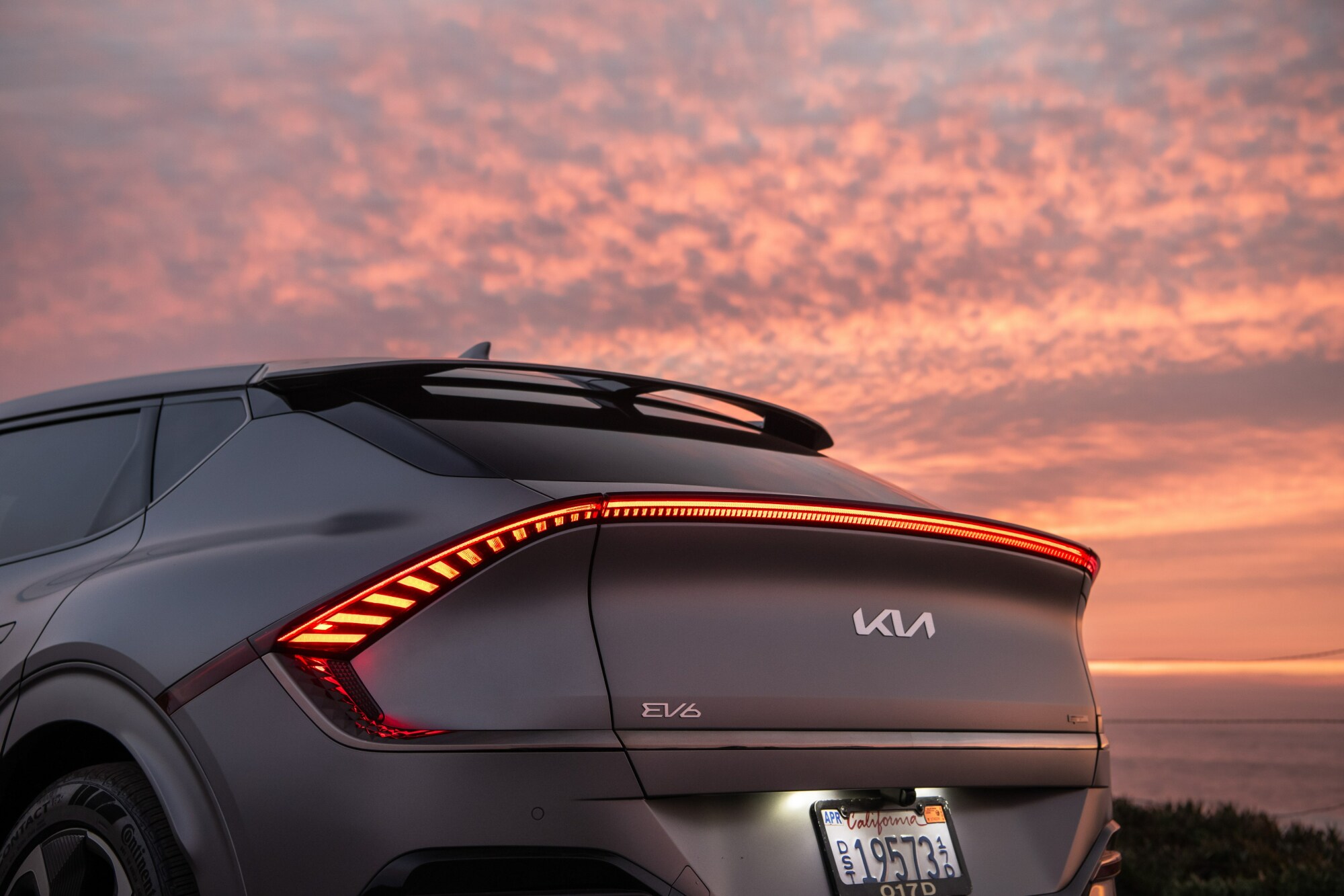 The back of the EV6 against a vibrant orange sunset.