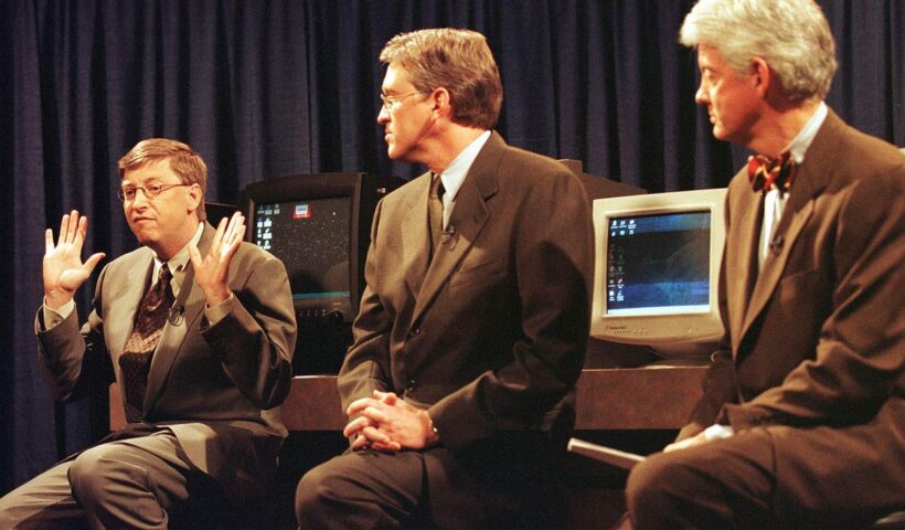 Microsoft co-founder Bill Gates, with executives Jeff Raikes (center) and Bill Neukom (right), talks about the Department of Justice’s antitrust lawsuit in 1998.