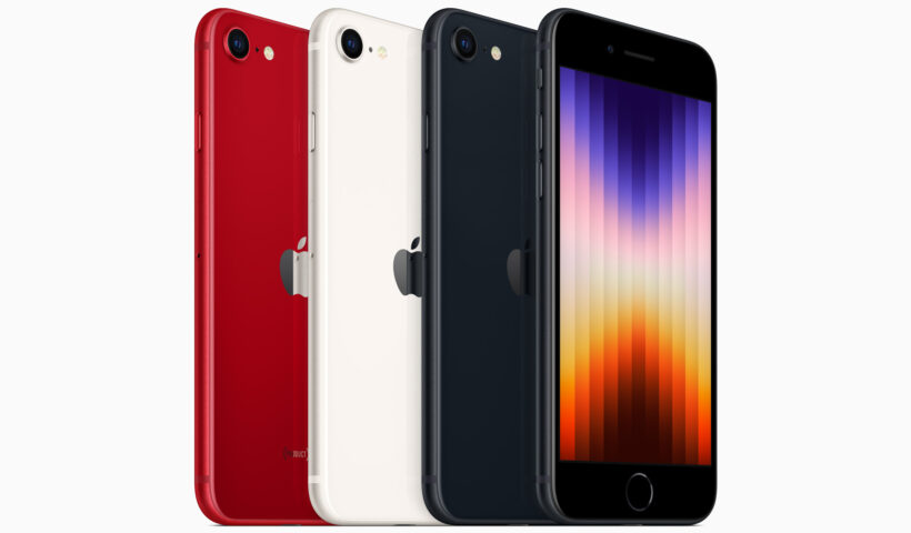 A red, white, and black iPhone lined up with a multicolored screen on the fourth phone on the right.