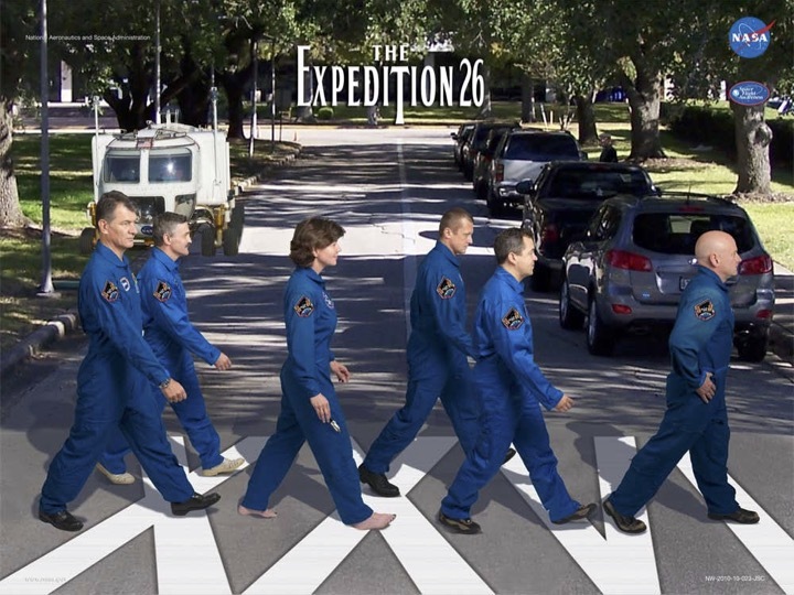 Astronauts posing in an Abbey Road-themed poster