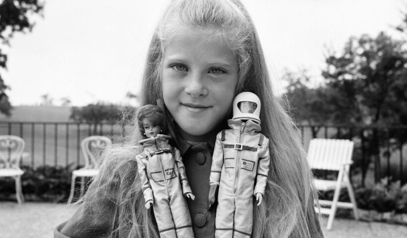 A girl playing with Miss Astronaut Barbie