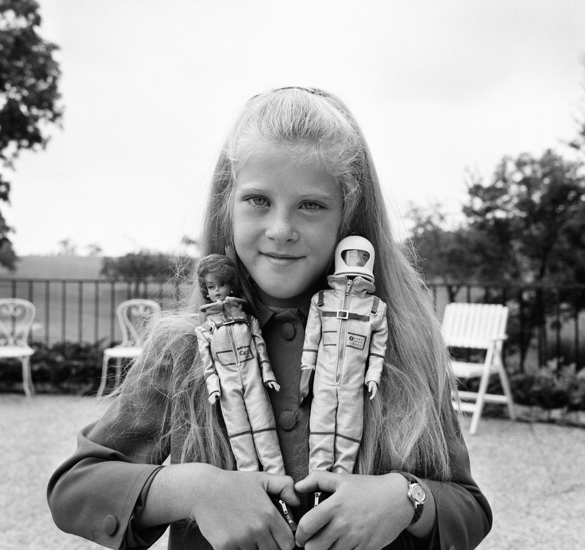 A girl playing with Miss Astronaut Barbie