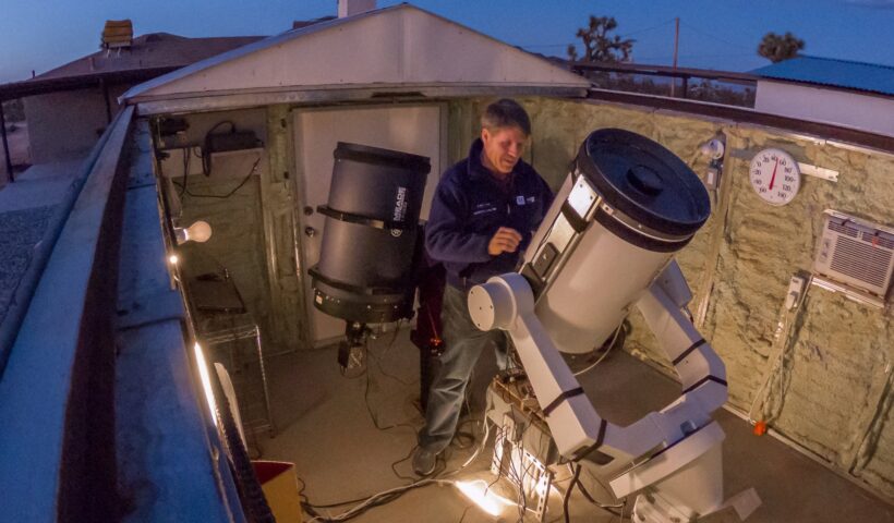 amateur astronomer working on telescope