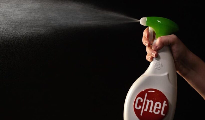 Person squeezing the handle on a bottle of cleaner