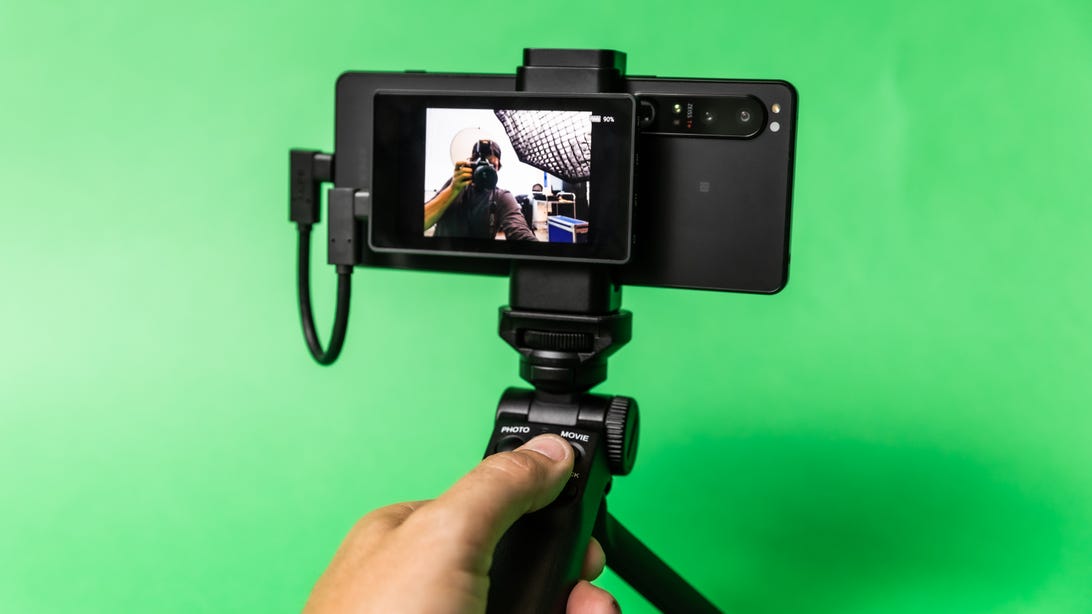 A Sony Xperia 1 IV in a shooting grip with a tiny monitor on the back of the phone